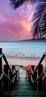 Stunning sunset view from a wooden stairway leading to a tropical beach.