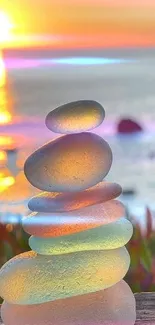 Stack of colorful sea glass stones with sunset background.