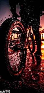 Bicycle silhouette against a vibrant sunset on a beach.