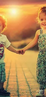 Two smiling children holding hands at sunset on a picturesque path.