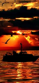 Silhouette of a boat at sunset with birds over a reflective ocean surface.