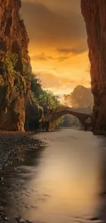 Sunset over canyon with ancient bridge reflecting in calm river.