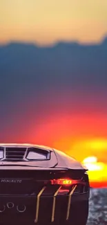 Silhouette of a car against a vibrant sunset background, perfect for wallpaper.