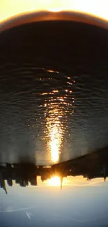 Fisheye view of sunset reflecting on water with city skyline.