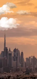 City skyline at sunset with orange sky and clouds.