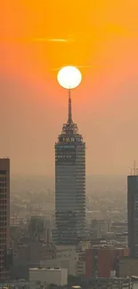 Orange sunset over city skyline with prominent skyscraper.