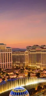 Cityscape at sunset with vibrant lights and iconic buildings.