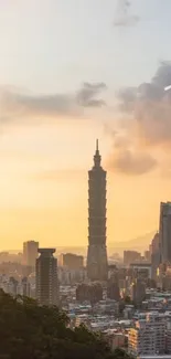 Sunset over a city skyline with an orange sky and towering skyscrapers.