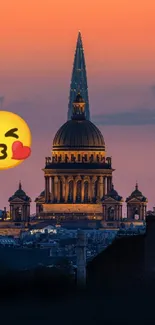 City skyline at sunset with a kiss emoji overlay.
