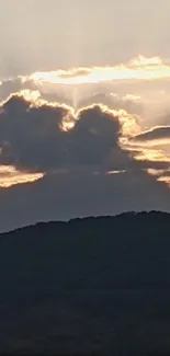 Dramatic clouds with sunset over hills scenery.