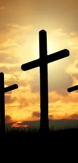 Silhouette of three crosses against a sunset sky for mobile wallpaper.