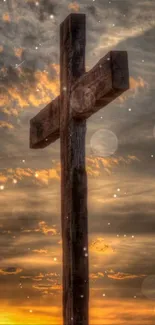 Wooden cross silhouetted against a vibrant sunset sky.