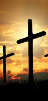 Silhouetted crosses set against a dramatic sunset sky.