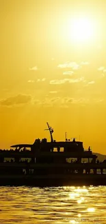 Silhouette of a boat against a golden sunset on the water.