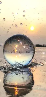 Crystal ball reflects sunset with splashing water droplets.