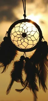 Dreamcatcher silhouetted against a golden sunset sky, exuding a bohemian style.