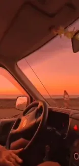 Car interior with sunset beach view through the windshield.