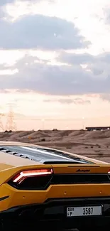 Yellow supercar driving through desert at sunset.
