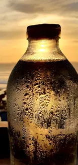 Sunset glow through a glass bottle with ocean view.