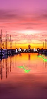 Sunset over harbor with boats reflecting in calm water.