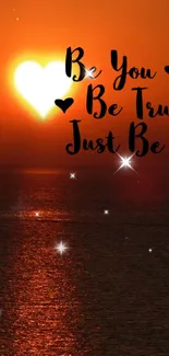 Heart-shaped sunset over ocean with motivational text.