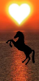 Vibrant sunset with horse silhouette and heart-shaped sun over the sea.