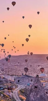 Hot air balloons at sunset over Cappadocia, creating a stunning evening view.