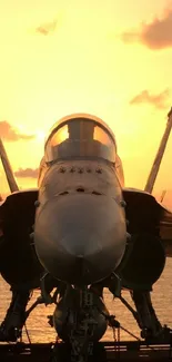 Fighter jet silhouette against a vibrant sunset sky over the ocean.