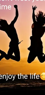 Two people leaping against a vibrant orange sunset backdrop.