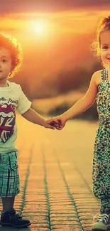 Two kids holding hands on a sunset-lit path.