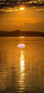 A whimsical pink pig floats on a golden lake at sunset.