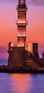 A lighthouse stands against a vibrant violet sunset, reflecting in ocean waters.