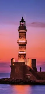 Lighthouse during sunset over a calm ocean.