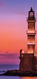 Lighthouse at sunset with a purple sky and calm ocean.