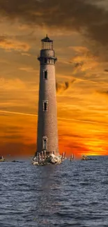 Lighthouse standing against a vibrant sunset ocean backdrop.