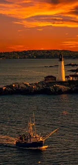 Lighthouse and boat under vibrant orange sunset sky.