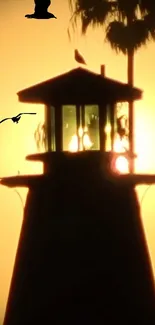 Lighthouse silhouette with sunset sky and flying birds.