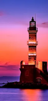 Lighthouse at sunset with a vibrant purple sky.