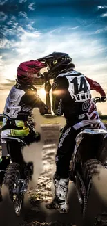 Motocross riders at sunset on dirt bikes.