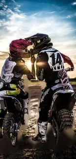 Motocross riders at sunset with vibrant sky.