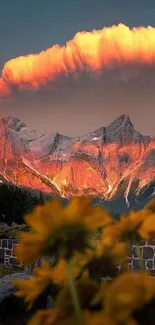 A stunning sunset over rugged mountains with vibrant orange clouds.