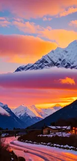 Stunning sunset over snowy mountain peaks with vibrant evening sky.