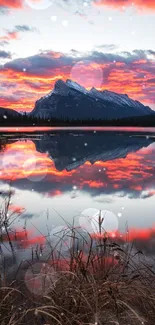 Vibrant sunset reflecting on calm lake with mountain in background.