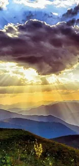 Sunset view over mountains with golden rays breaking through clouds.