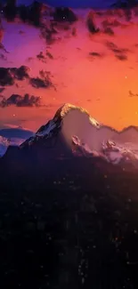 Dramatic sunset over snowy mountain peaks with rich purple and orange hues.