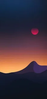 Wallpaper of a sunset over silhouetted mountains with a gradient sky.