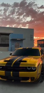 Yellow muscle car under a sunset sky.