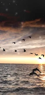 Serene sunset with flying birds over the ocean, creating a tranquil mobile wallpaper.