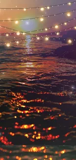 Sunset ocean with glowing string lights reflecting on water.