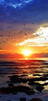 Vibrant ocean sunset with birds flying above.